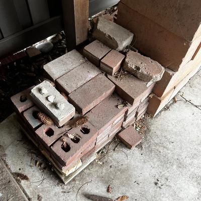 Behind GARAGE -- pile of block and brick used 