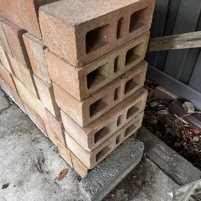 Behind GARAGE -- pile of block and brick used 
