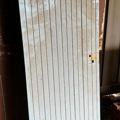 Behind GARAGE -- bead board door