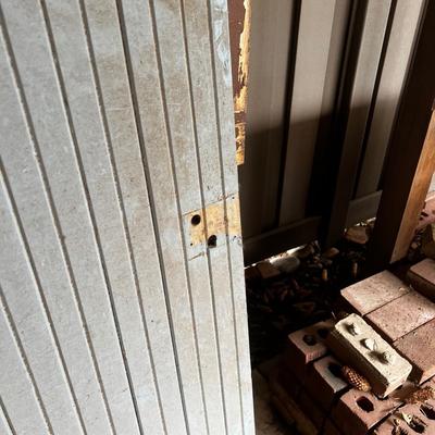 Behind GARAGE -- bead board door