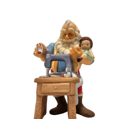 santa sewing porcelain figurine