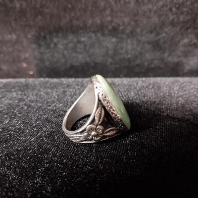 GREEN OVAL STONE SET IN SILVER PLATE