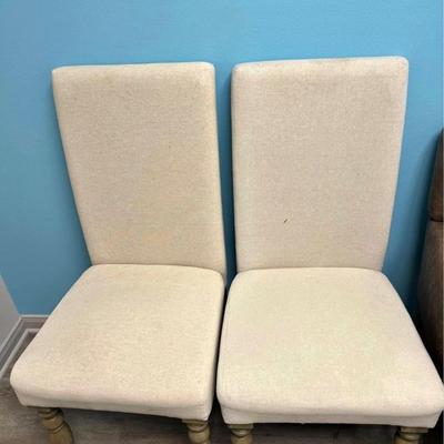 2  light  beige  fabric accent chairs.  Beautiful wooden carved legs.