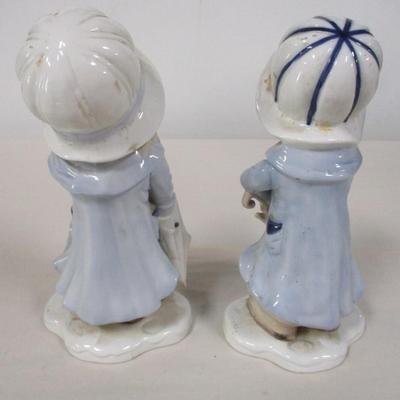 Porcelain Boy & Girl in Raincoats Figurines