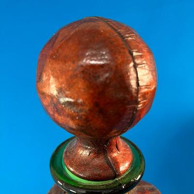 MYSTERIOUS LEATHER COVERED GLASS JAR WITH STOPPER AND METALLIC CREST 