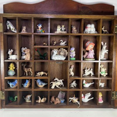 Wall mounted wood shadow box with collectible smalls