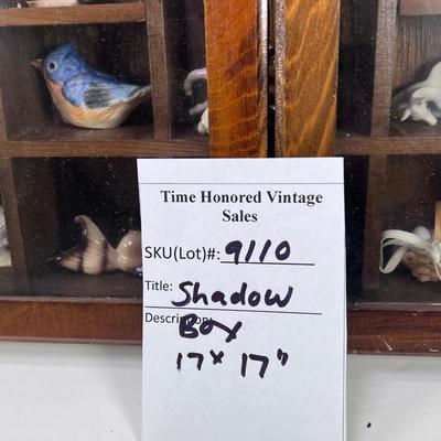 Wall mounted wood shadow box with collectible smalls