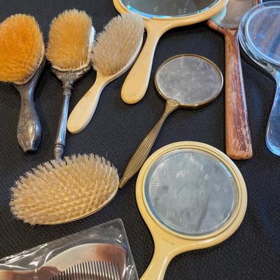 Multiple vintage mirrors and brushes