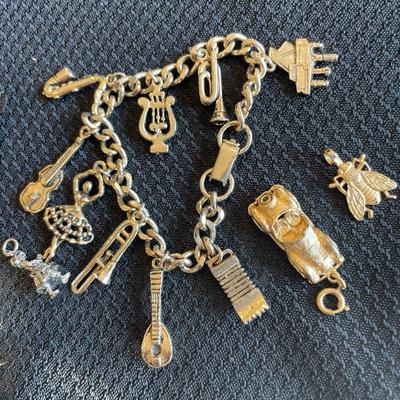 Gold tone charm bracelet and charms
