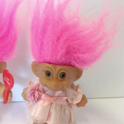 He loves her buns!  Pink haired troll dolls - Boy with I love your buns sign and girl in dress