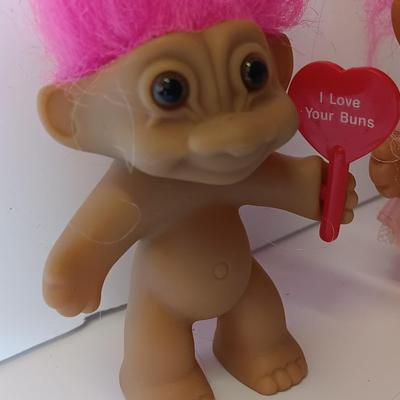 He loves her buns!  Pink haired troll dolls - Boy with I love your buns sign and girl in dress
