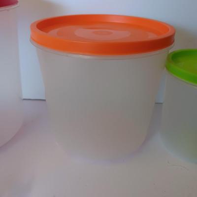 Three plastic lidded food storage containers with Fire King measuring glass
