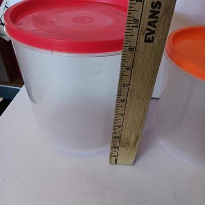 Three plastic lidded food storage containers with Fire King measuring glass
