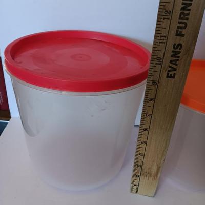 Three plastic lidded food storage containers with Fire King measuring glass