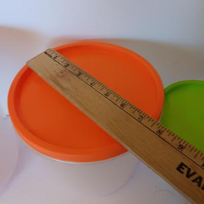 Three plastic lidded food storage containers with Fire King measuring glass