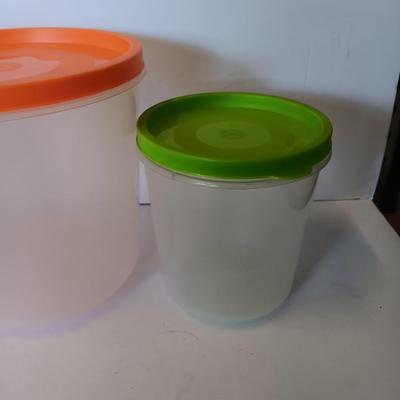 Three plastic lidded food storage containers with Fire King measuring glass