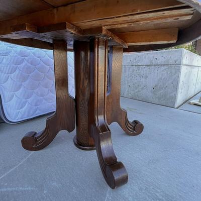 ROUND OAK DINING TABLE WITH 2 LEAVES ON WHEELS PEDESTAL BASE