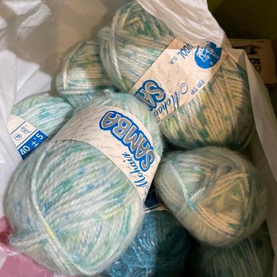 Tote of yarn and containers of spools of thread