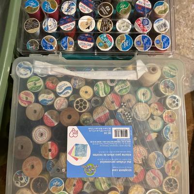Tote of yarn and containers of spools of thread
