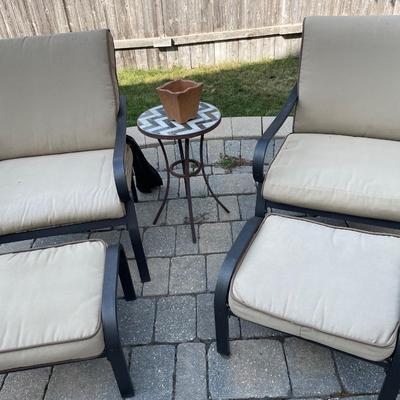 2 patio chairs and foot rests and table