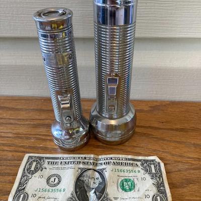 Two matching big and small vintage metal flashlights