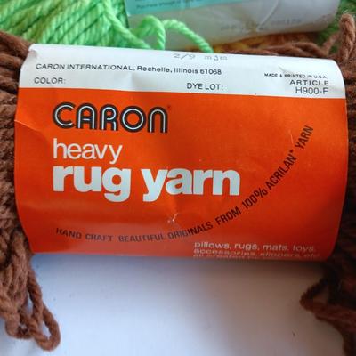 8 skeins of Caron Heavy rug yarn and one black, red heart brand yarn