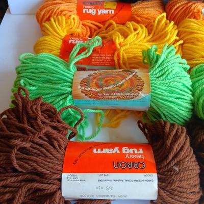8 skeins of Caron Heavy rug yarn and one black, red heart brand yarn