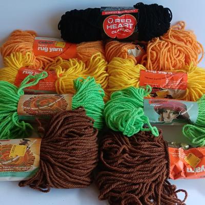 8 skeins of Caron Heavy rug yarn and one black, red heart brand yarn