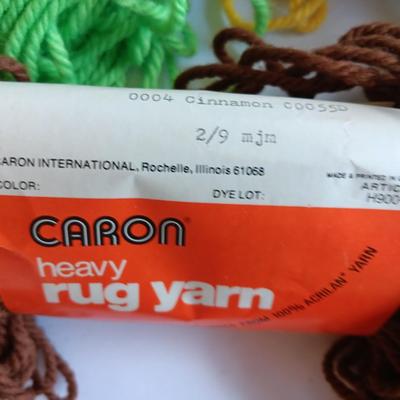 8 skeins of Caron Heavy rug yarn and one black, red heart brand yarn