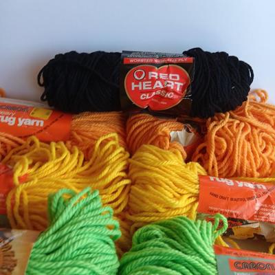 8 skeins of Caron Heavy rug yarn and one black, red heart brand yarn