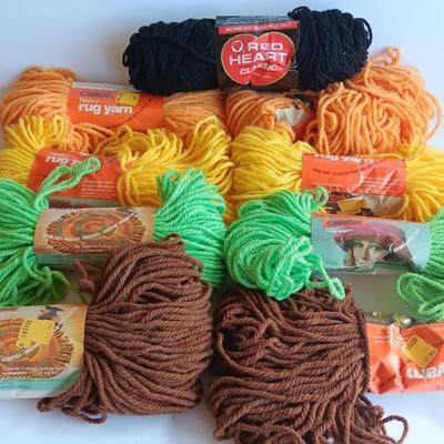 8 skeins of Caron Heavy rug yarn and one black, red heart brand yarn