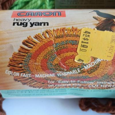 8 skeins of Caron Heavy rug yarn and one black, red heart brand yarn