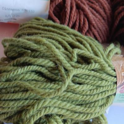 7 skeins of Caron Heavy rug yarn and two black, red heart brand yarn (1 of 2)