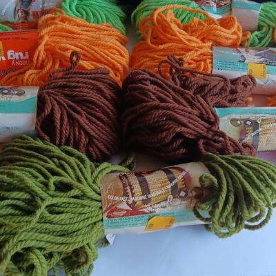 7 skeins of Caron Heavy rug yarn and two black, red heart brand yarn (1 of 2)