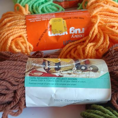 7 skeins of Caron Heavy rug yarn and two black, red heart brand yarn (1 of 2)