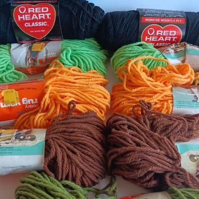 7 skeins of Caron Heavy rug yarn and two black, red heart brand yarn (1 of 2)