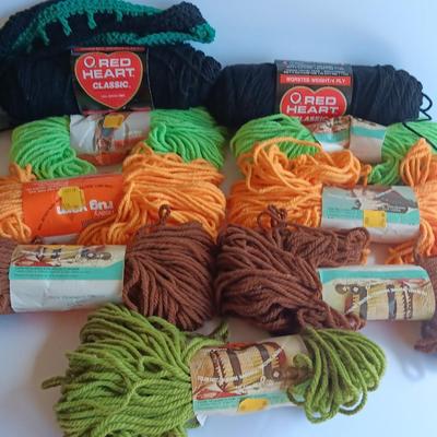 7 skeins of Caron Heavy rug yarn and two black, red heart brand yarn (1 of 2)