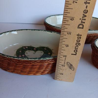 Three heart design nesting bowls each with its own basket.  Heavy ceramic