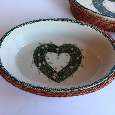 Three heart design nesting bowls each with its own basket.  Heavy ceramic