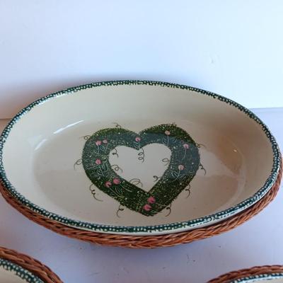Three heart design nesting bowls each with its own basket.  Heavy ceramic