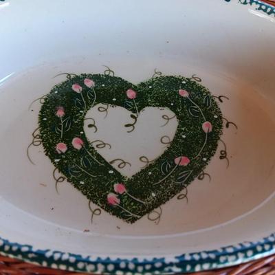 Three heart design nesting bowls each with its own basket.  Heavy ceramic