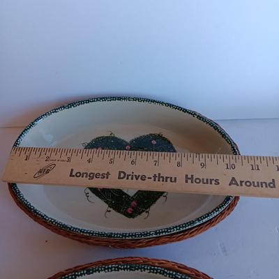 Three heart design nesting bowls each with its own basket.  Heavy ceramic