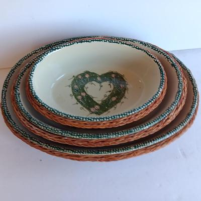 Three heart design nesting bowls each with its own basket.  Heavy ceramic