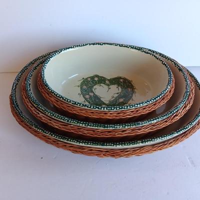 Three heart design nesting bowls each with its own basket.  Heavy ceramic