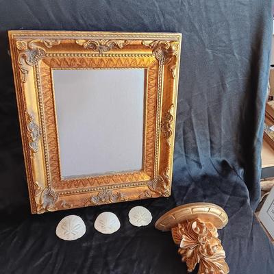 Gold decorative framed wall mirror with wall shelf and Sand dollars