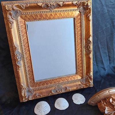 Gold decorative framed wall mirror with wall shelf and Sand dollars