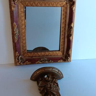 Gold and maroon decorative framed wall mirror with small shelf