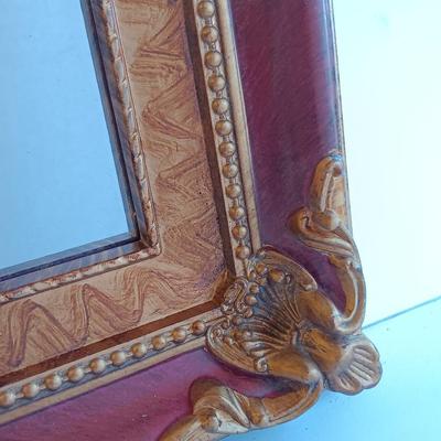 Gold and maroon decorative framed wall mirror with small shelf