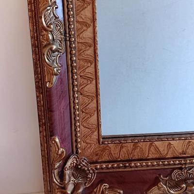 Gold and maroon decorative framed wall mirror with small shelf