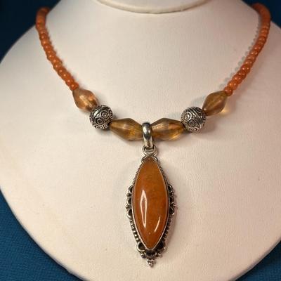 LOVELY ORANGE-BROWN POLISHED STONE MEDALLION, BEADED NECKLACE